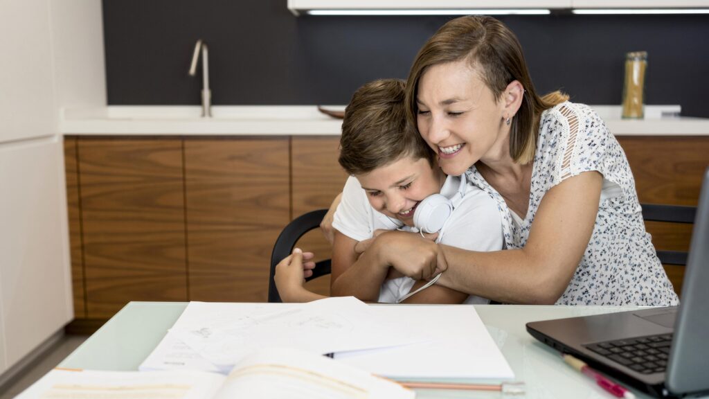 Parent hugs child during homework, showing effective homework routines for busy families.