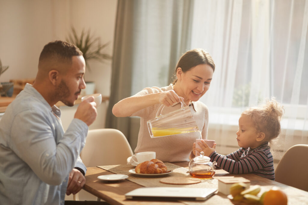 Family enjoying breakfast together at home, showing how to parent with confidence every day through daily routines.