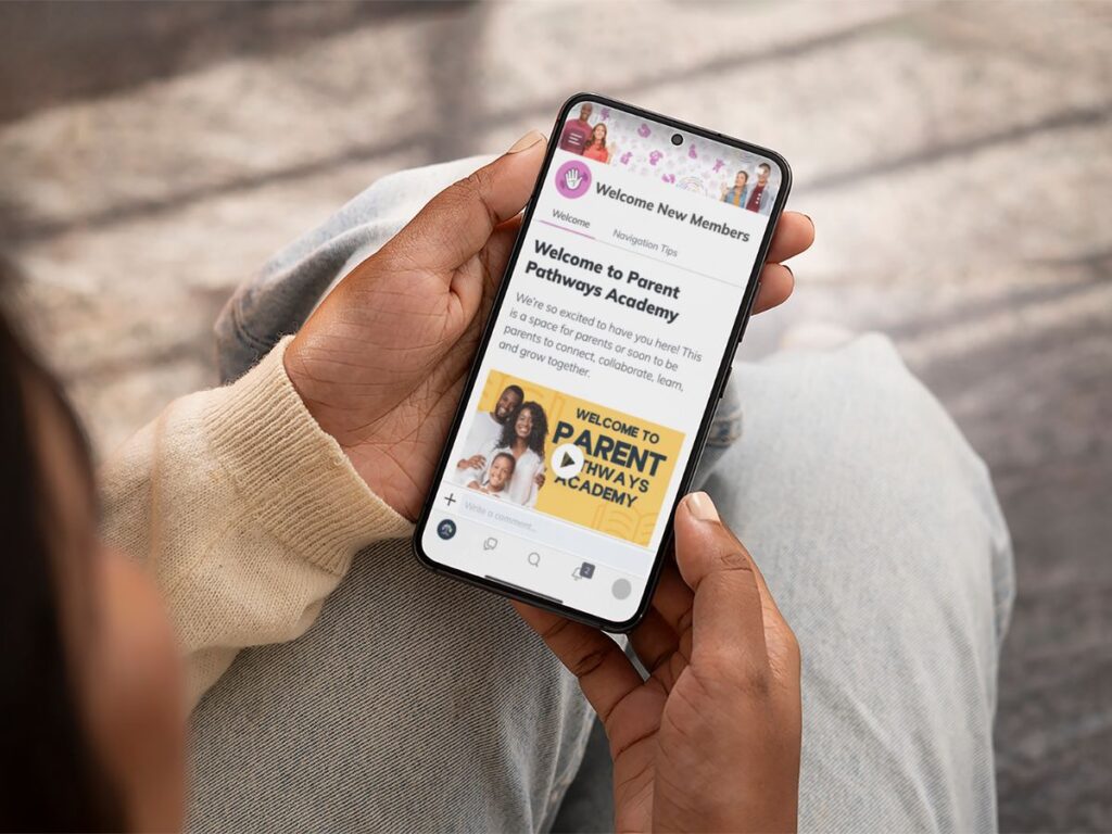 A parent holds a phone showing the Parent Pathways Academy welcome page, offering family support resources and tips for morning routines for working parents.
