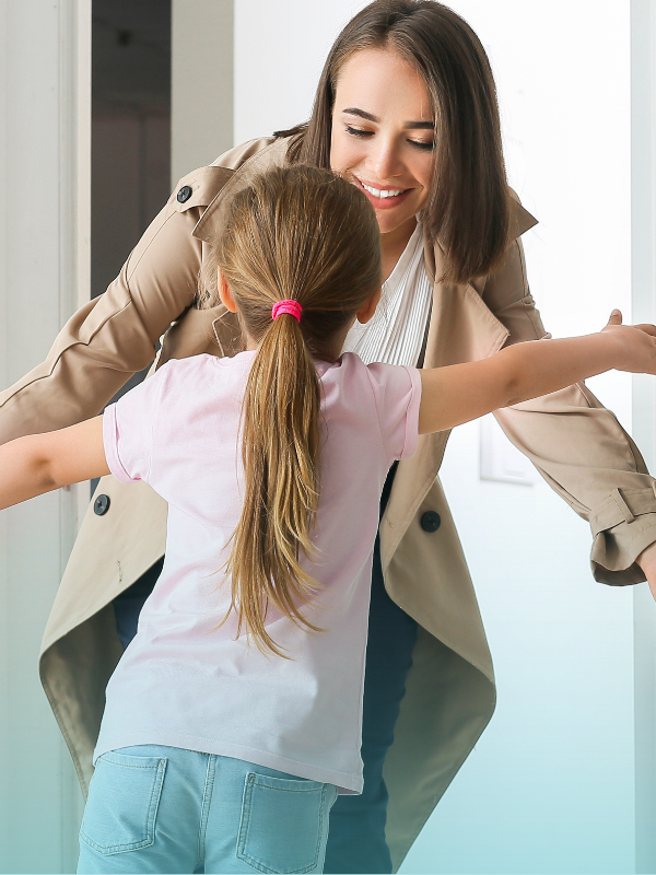 Parent greeting her daughter with open arms, demonstrating listening and reassurance in mental health first aid steps.